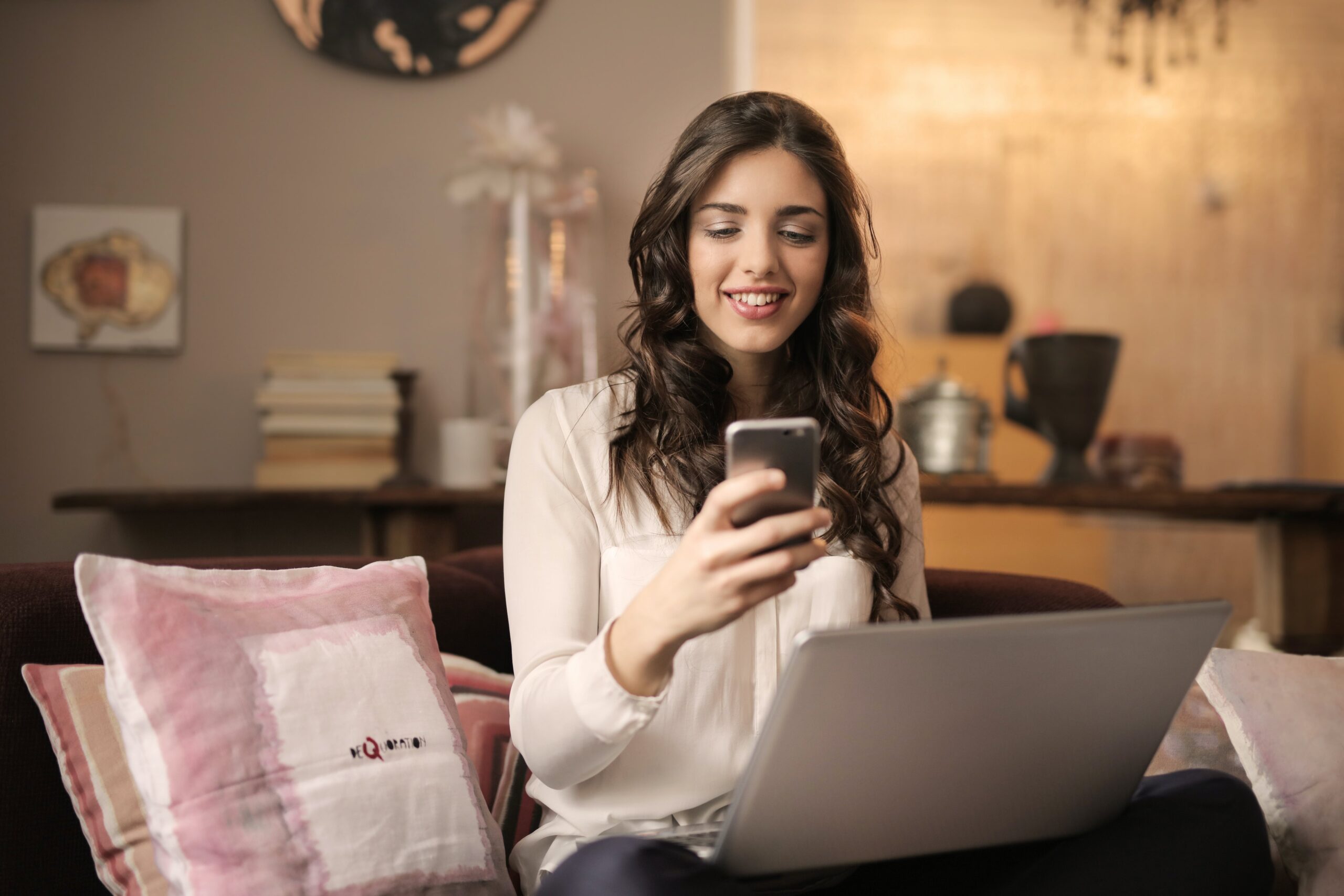 girl-texting-in-front-of-laptop