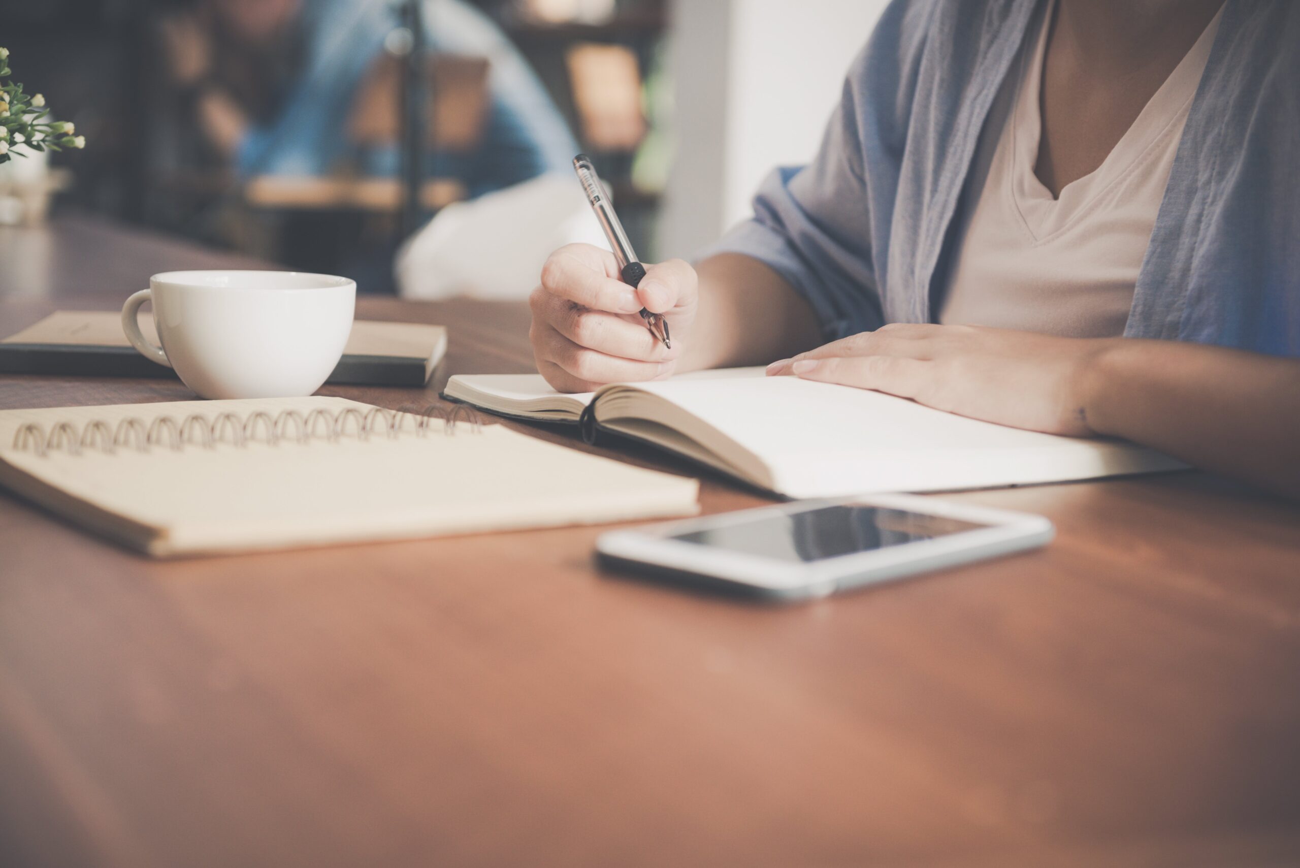 woman-writing-on-notebook