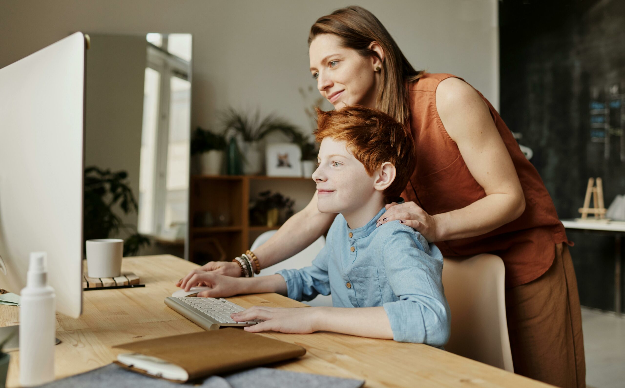 person-and-child-sitting-at-a-desk